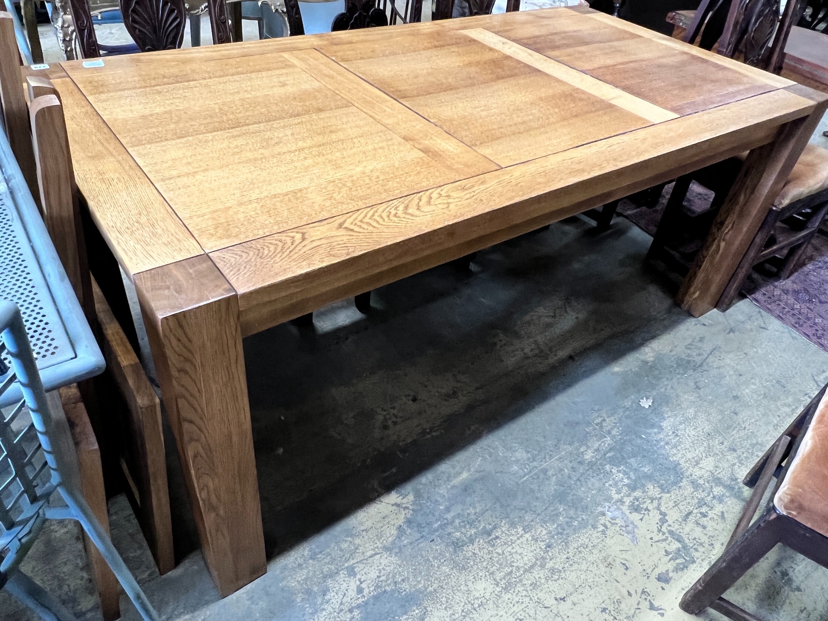 A large contemporary rectangular oak dining table, with removable end leaves, length 280cm extended, width 90cm, height 75cm